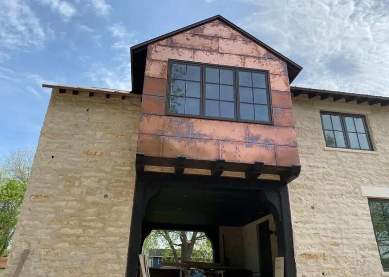 Copper metal panel facade on a stone building for Skylight Installation in Indiantown