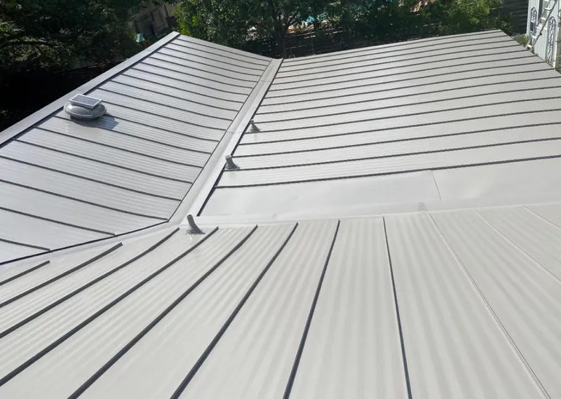 Solar attic fan installed on a metal roof for Roof Ventilation in Indiantown